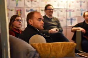 man listening intently to discussion