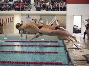 A male UWO swimmer propels off the diving board into the water against Ripon College on Feb. 15. While both swim teams did not place high enough to advance to the Division-III championship, both dive teams advanced.