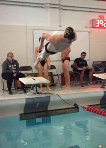 A male UWO swimmer propels off the diving board into the water against Ripon College on Feb. 15. While both swim teams did not place high enough to advance to the Division-III championship, both dive teams advanced. 