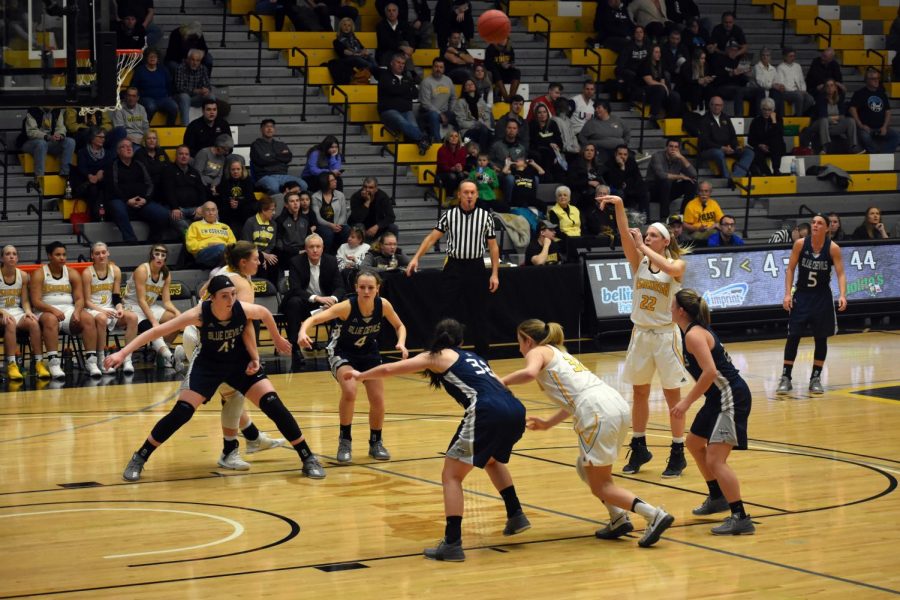 UW+Oshkosh+junior+forward+Melanie+Schneider+releases+a+free+throw+as+freshman+Karsyn+Rueth+%28left%29+and+senior+Madeline+Staples+%28No.+32%29+move+off+the+block+to+gain+position+for+a+potential+rebound.+In+the+regular+season+finale+against+UW-Stout%2C+Schneider+had+five+points.