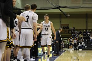 Sophomore forward Jack Flynn receives high fives from teammates after checking out of the game against Emory University.