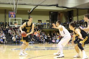 Sophomore forward Adam Fravert looks to move the ball down into the post in the first half against Augustana College Saturday.