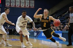 Junior guard Ben Boots drives around a Ramapo defender on the way to the hoop on Friday.