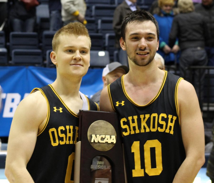 Senior guard Charlie Noone and senior guard Jake Laihnen pose with the sectional championship trophy.