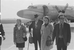 March (left) arrives at the Wittman Regional Airport in Oshkosh with his wife (right) and others.
