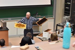 Executive Director for the Nicaragua Bee Project Michael Bauer shows audience beekeeping supplies.
