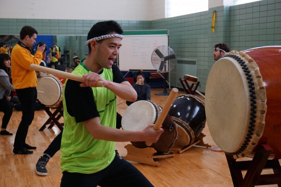 Faculty adviser for Oshkosh Taiko Yoshiro Hanai demonstrates how to play the Taiko.
