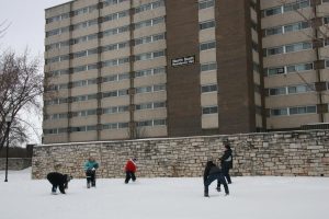  Students have a snowball fight in the fresh April snow in front of North Scott Residence Hall after the blizzard. 