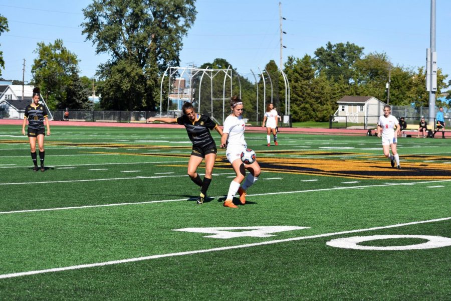 Sophomore midfielder Addie Schmitz attempts to take the ball away from an MSOE player. The Titans beat the Raiders 2-1 in overtime.