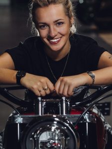 Harley Davidson intern Tessa Otto poses with the 2018 Twisted Cherry Street Glide Special she received as an intern.