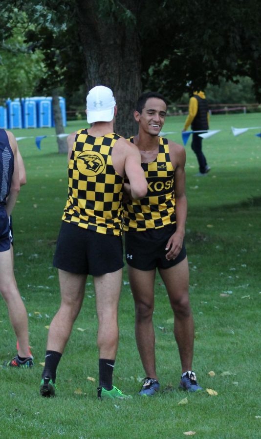 Freshman Steven Potter celebrates with a teammate after finishing eighth at the home meet. 