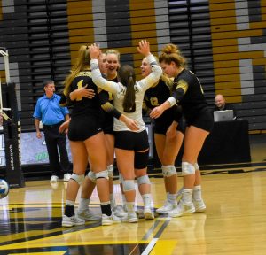 UWO volleyball members celebrate earning a point during the Pizza Hut Classic.