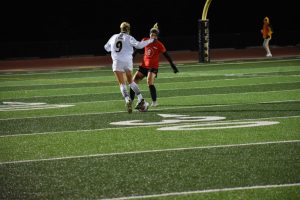 Senior Alexis Brewer dribbles around a UW-River Falls defender on Saturday night. The Titans came away with a 2-0 victory, improving to 3-3 in the WIAC.