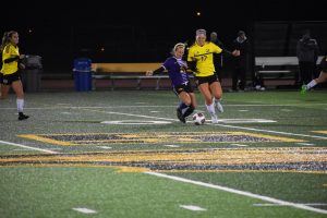 Tory Schumann fights for the ball near midfield.