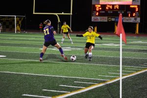 UWO defender Taylor Simkowski meets Pointer defender at the ball while UWO midfielder Maddie Morris watches from a far.