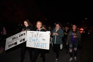 Marchers show off their signs in support of Take Back the Night.