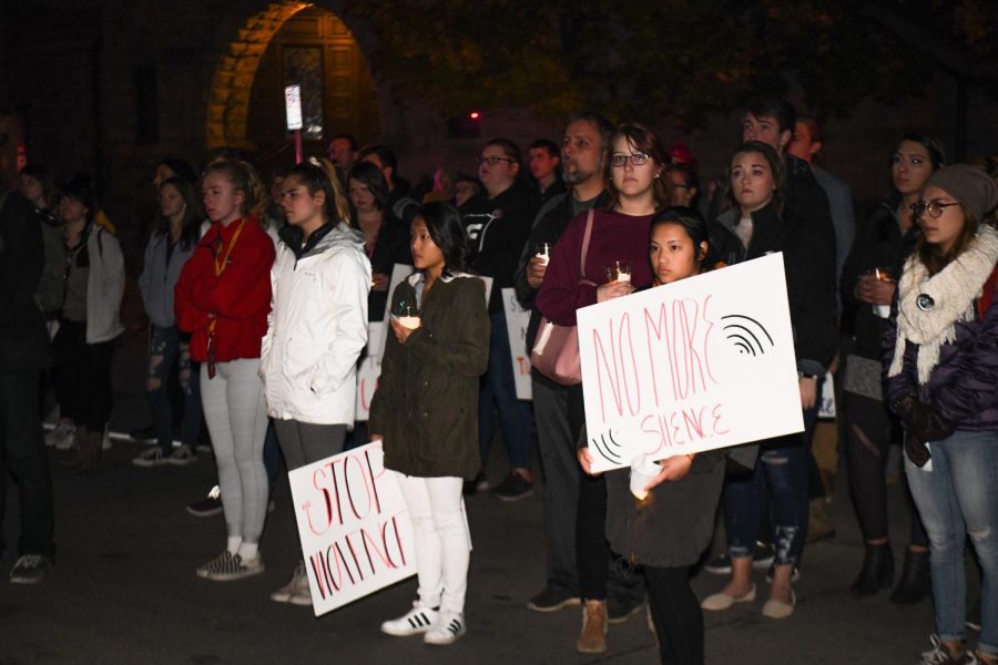 Participants honor those lost to sexual assault outside of the Christine Ann Center with a moment of silence.