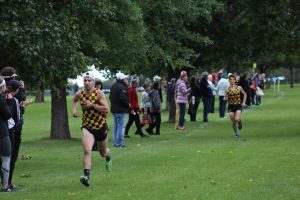 Senior Jacob Rost tries to improve his finishing time as freshman Andrew Muskevitsch attempts to catch him.