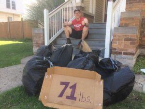 Jeremy Piper, co-founder of the new, UWO club Titan Students for a Cleaner Community, poses with garbage collected by students on and around campus.