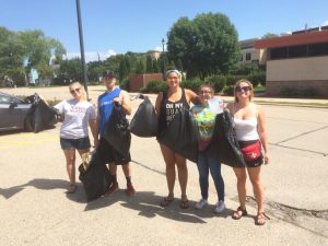 From left, Natalie Kostman, Jeremy Piper, Elizabeth Armstrong, Miklyn Armstrong and Emily Eresh present a large amount of garbage collected during an outing to clean the campus.