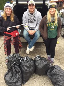 From left, Emily Eresh, William Nebus and Natalie Kostman pose with garbage collector equipment.