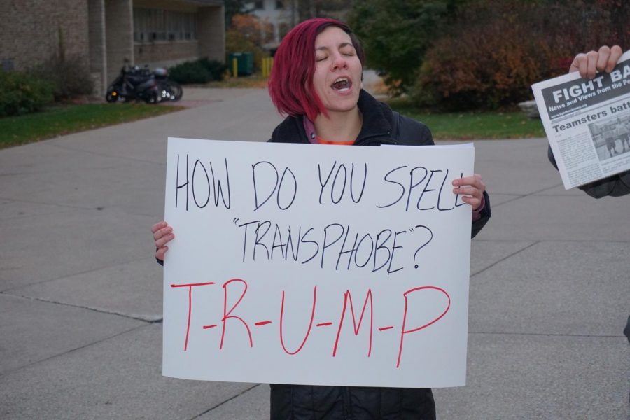 Student displays homemade sign and joins in the protest for transgender rights.
