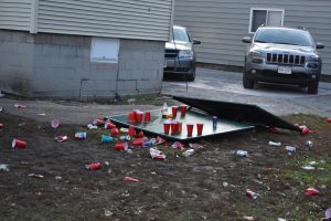 Trash is left on the yard of a student residence during fall 2018 pub crawl. 