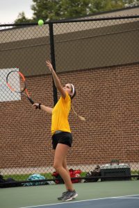 Junior Alyssa Leffler serves a ball to her opponent.