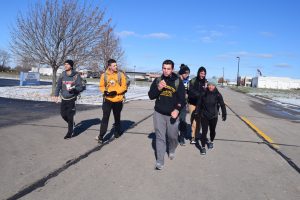 A group of Oshkosh Cadets continue on their ruck after stopping at the 8-mile mark for a quick lunch.