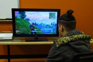 Students focus on the screen as they play games.