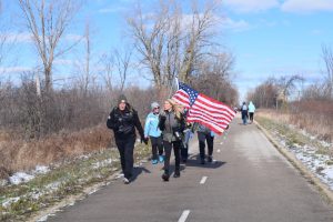 A guest speaker who lost her fiancé to suicide, hiked with her husband’s rucksack on her back. She intended to do the race for two miles, but later decided to do the full 20-mile ruck, all with his rucksack.