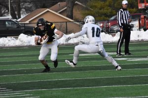 UWO running back J.P. Peerenboom protects the ball on one of his eight carries against UW-Stout.