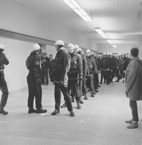 Police line up and down Dempsey hallways, ready to escort students to idling vans.