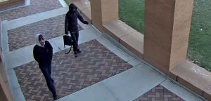 Video surveillance of suspects walking under covered sidewalk between horizon and reeve 