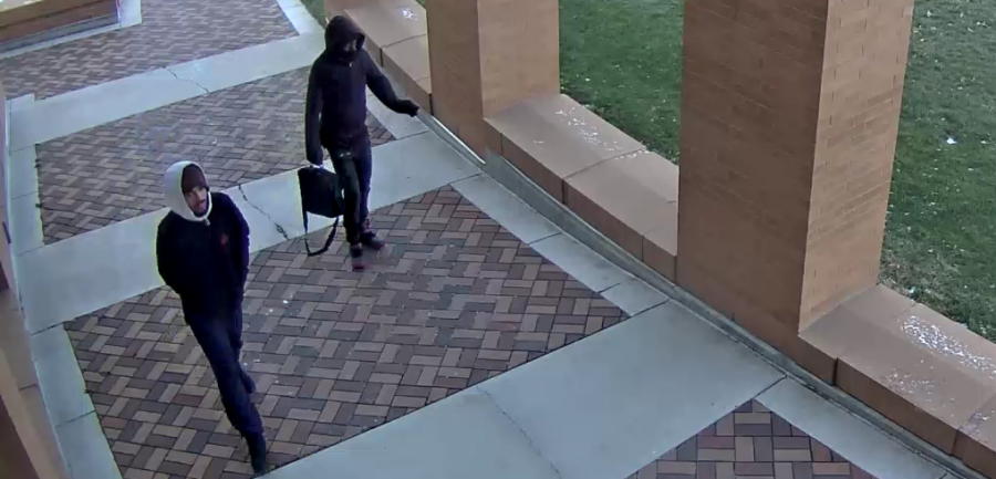 Video surveillance of suspects walking under covered sidewalk between horizon and reeve