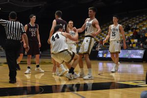 Junior Brett Wittchow (4) helps teammate Jack Flynn (44) up as Adam Fravert and Ben Boots look on.