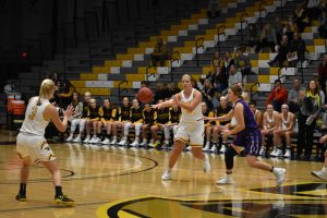 Sophomore Nikki Arneson passes the ball to freshman Brooke Freitag.