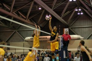Travis Hudson rises above opponents to spike the ball. Hudson played at UW Oshkosh from 2013-17.