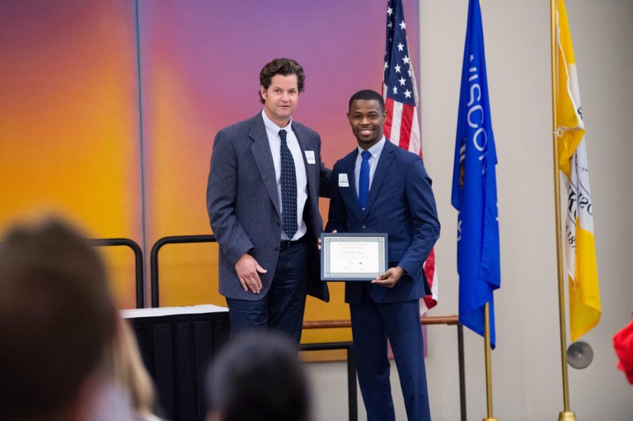 History Professor Stephen Kercher presents Franklyn Iwuji with the African-American Student Leadership award at the Martin Luther King Jr. community Celebration on Monday, Jan. 21 2019 at the AWCC.