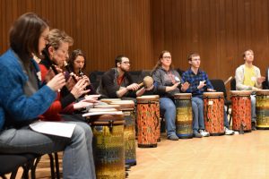 Techniques of Orff instrumentation are demonstrated to the audience.