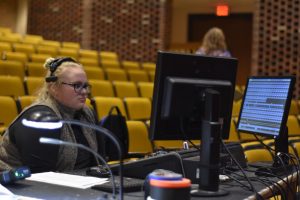 UWO junior Hannah Olsen sets lights for rehearsal of the show. 