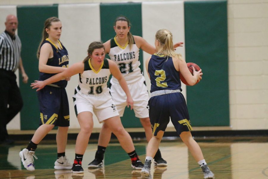 Falcons No. 10 Camryn Garriety and No. 21 Cassidy Williams defend offensive possession.