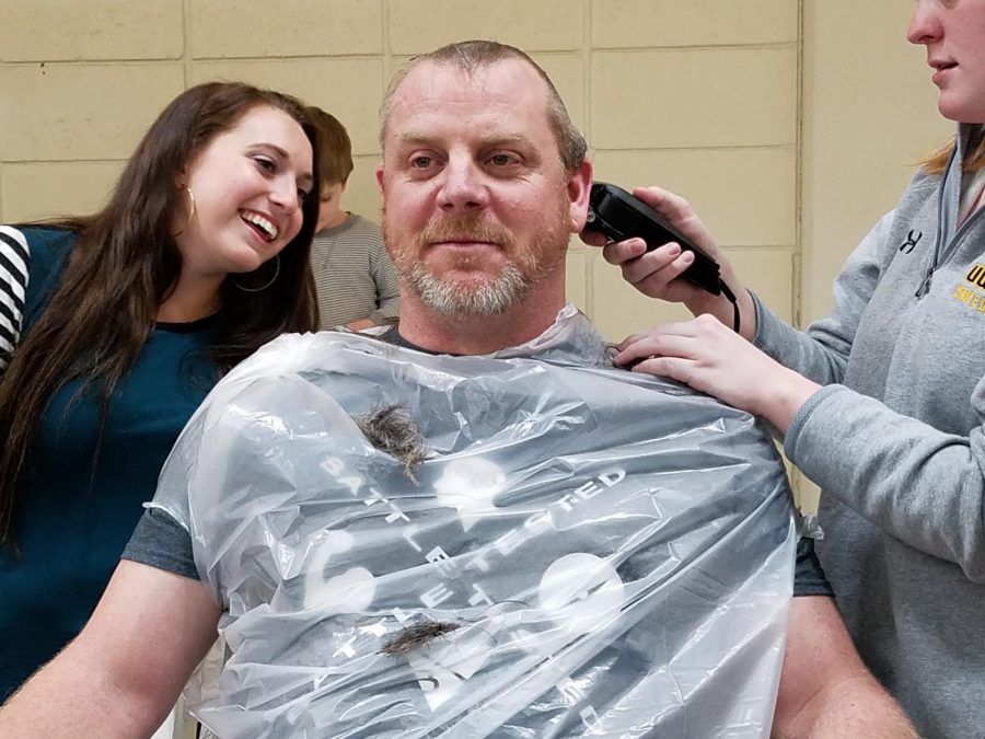 UWO swim and dive head coach Christopher Culp gets his head shaved to fulfill the bet he made with his team after they set numerous school records at the WIAC Championship last weekend. Culp told his team to get five records, they set ten.