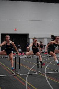 UWO Sadie Huth sprints through the first set of hurdles in the 60-meter dash.