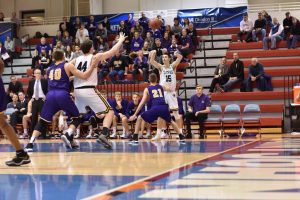 Junior forward Adam Fravert tosses a pass to the paint where fellow junior Jack Flynn is backing down a Northwestern defender.