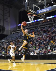 Senior Brett Wittchow goes in for a breakaway layup at the end of the first half against Swarthmore College. Wittchow scored 14 in his final game in a Titan uniform.