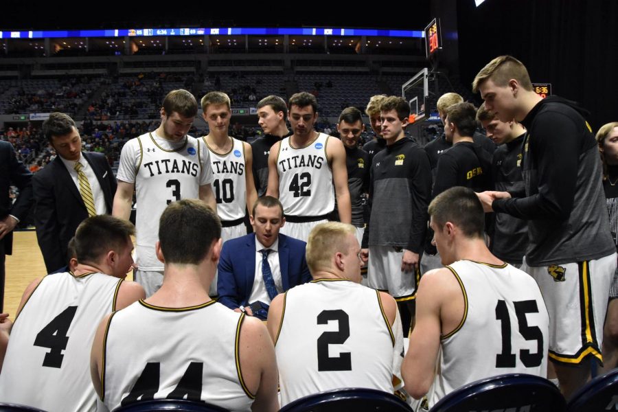 Titan head coach Matt Lewis talks to his starters during a timeout at Allen County War Memorial Coliseum in Fort Wayne, Indiana. With the win, the Titans advance to play Swarthmore College in the NCAA Division III Mens Basketball National Championship Game.