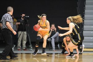 Senior forward Melanie Schneider gathers a rebound after a missed attempt by the Tigers' offense.