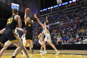 Titan junior Jack Flynn shoots a baby hook shot over Garnet defender.