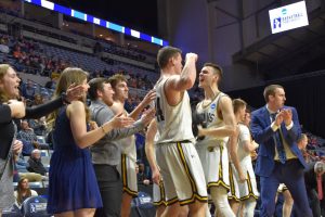Mens Basketball cheers after defeating Wheaton